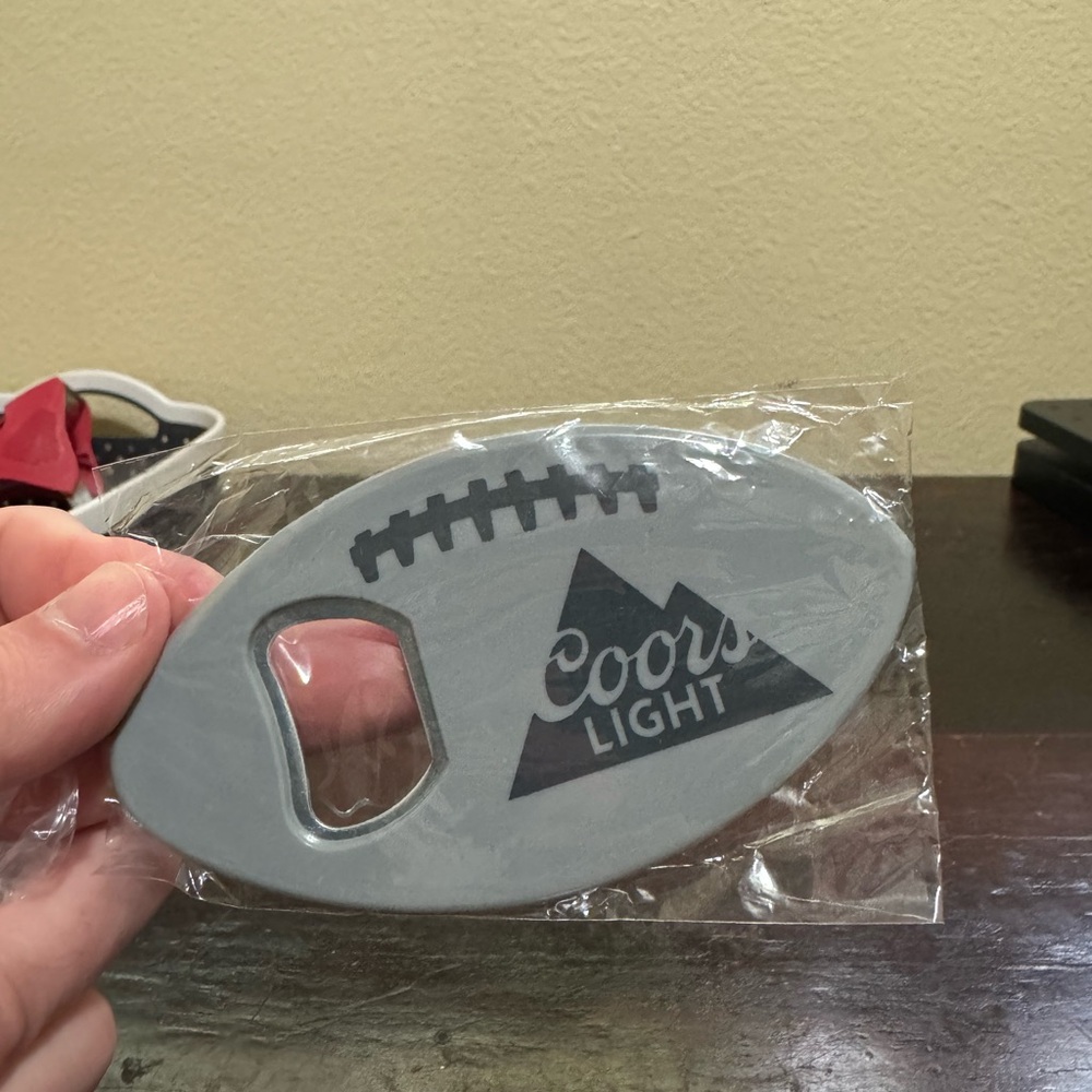 Coors Light Football Bottle Opener. New in Package.